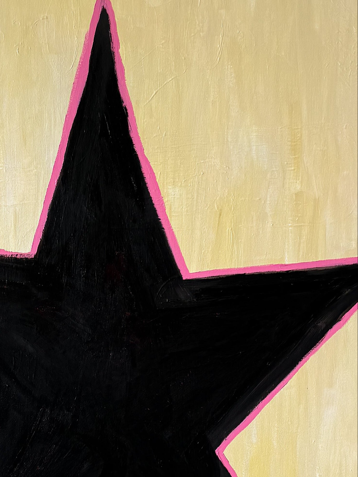 Black star with pink outline on a beige background
