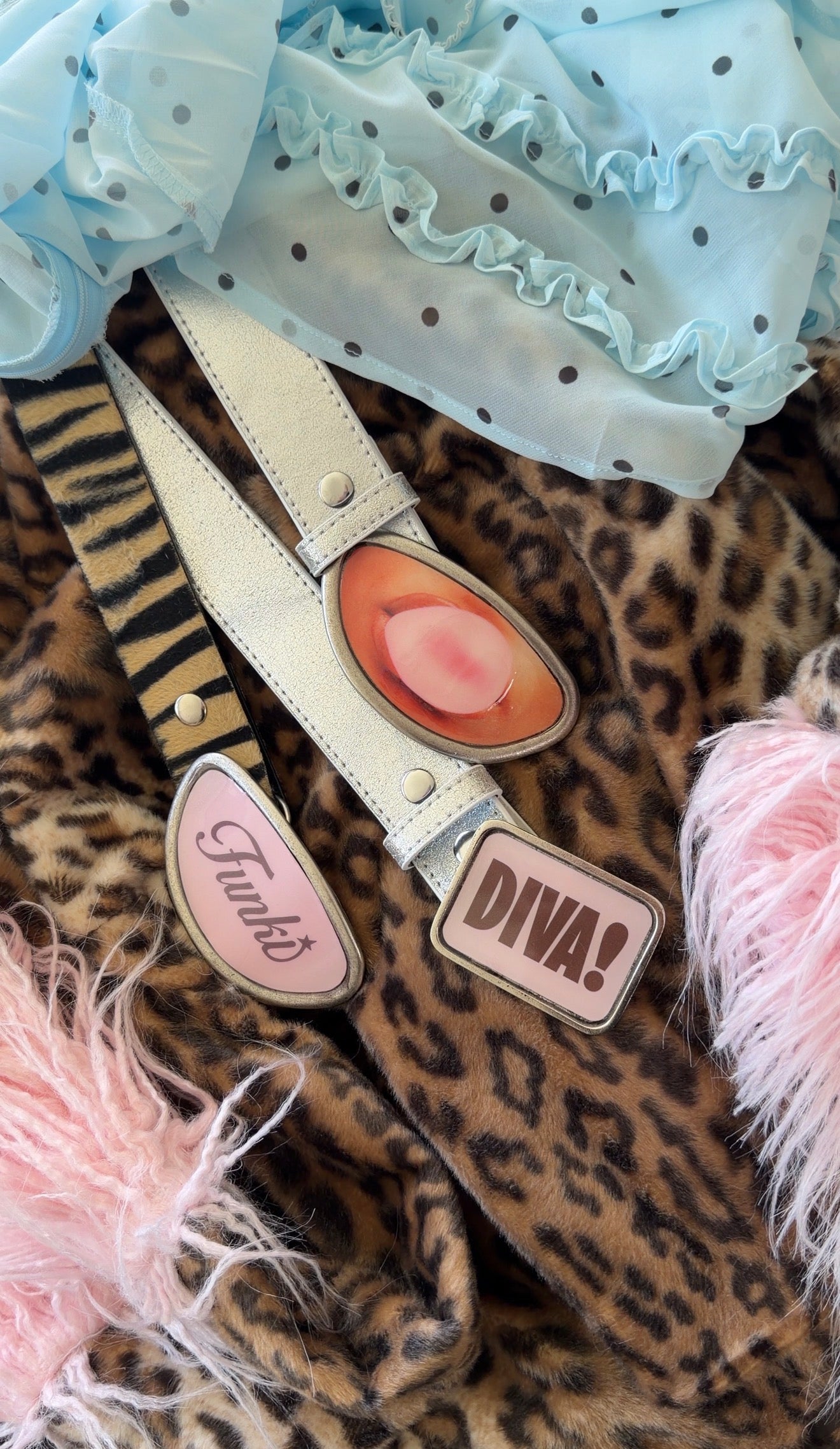 Belt with decorative buckle on a leopard print fabric background